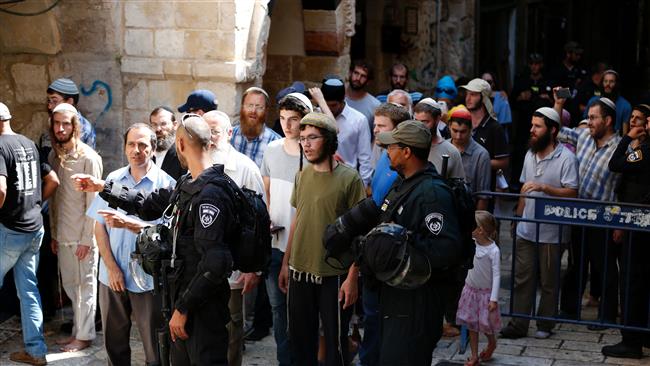 Israeli security forces stand guard as a group of settlers leave the al-Aqsa Mosque