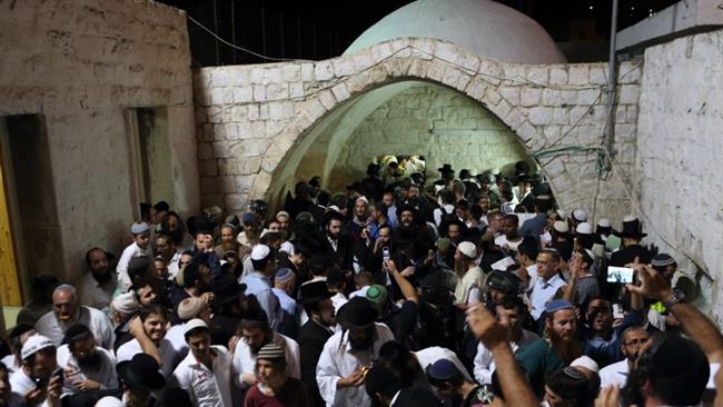 In this file photo, hundreds of illegal Israeli settlers pray near the compound of Joseph