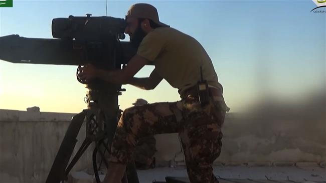 This screen grab on July 12, 2016 shows a militant firing a US-made TOW missile toward Syrian soldiers positioned on Aleppo