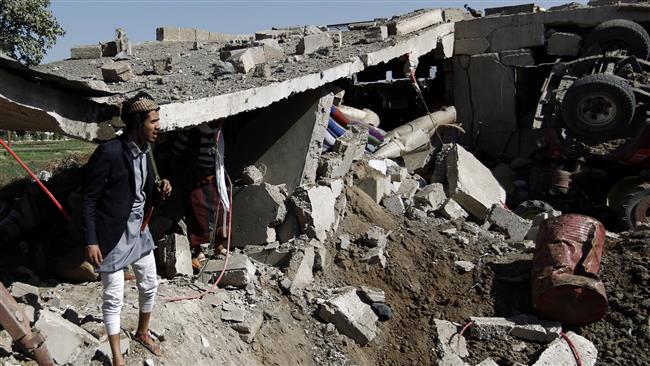 People check the destruction following a Saudi airstrike on Yemen