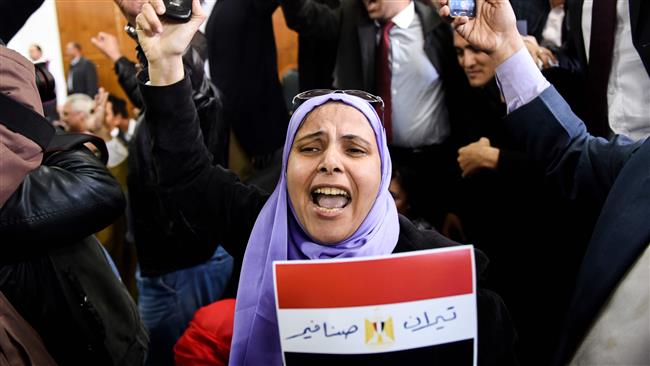 An Egyptian woman celebrates with a national flag on January 16, 2017, after a ruling against the government’s islands deal with Saudi Arabia. (Photo by AFP)
