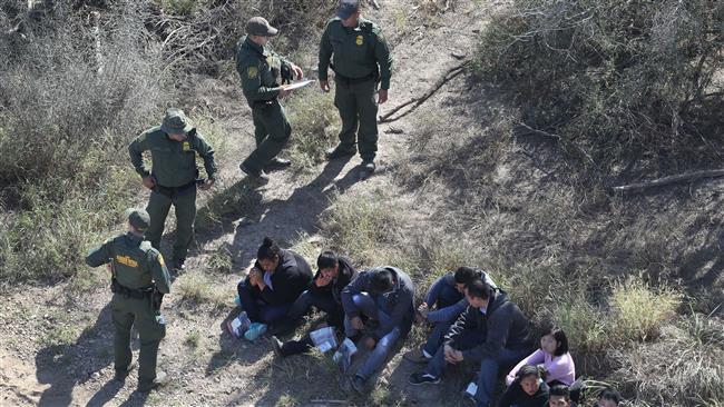 US Border Patrol agents watch over immigrants who crossed the US-Mexico border near McAllen, Texas, January 3, 2017.