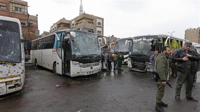 Syrian security forces and locals gather at the scene of a twin bombing targeting Shia pilgrims in Damascus