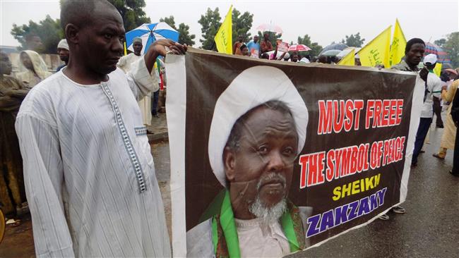 Protesters from the Islamic Movement in Nigeria (IMN) holding a banner with a photograph of detained leader Ibrahim Zakzaky
