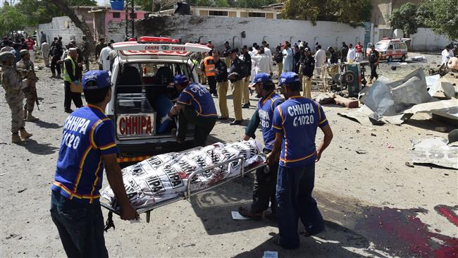 Pakistani medic volunteers transport the body of a victim at the site of an explosion in Quetta, southern Pakistan, June 23, 2017.
