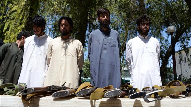 Suspected Daesh members stand next to weapons as they are presented to the media at the police headquarters in Jalalabad, Afghanistan, May 29, 2017. (Photo by AFP)
