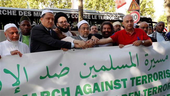 The Imam of Drancy, Hassen Chalghoumi, (2nd L) and other Muslim leaders along with French writer Marek Halter (2nd R) pose behind a banner as they prepare to take part in The Muslim March Against Terrorism in Paris on July 8, 2017. (Photo by AFP)
