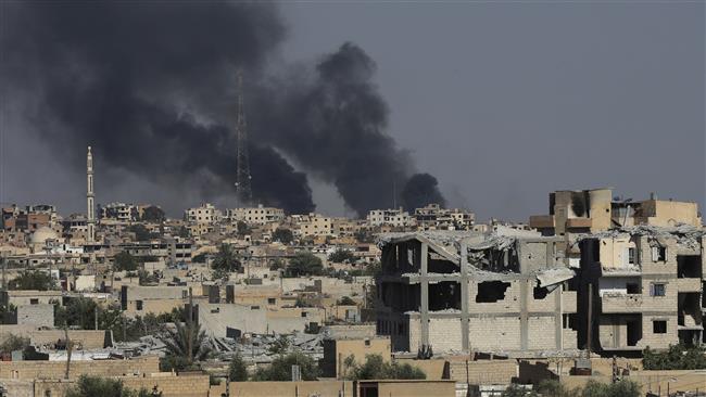 Smoke rises from Raqqah City where US-backed Syrian Democratic Forces fighters battle against Daesh Takfiri terrorists on July 27, 2017. (Photo by AP)
