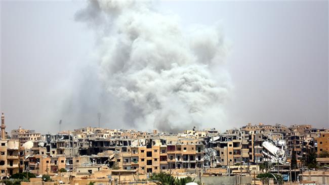 Smoke billows out from the Syrian city of Raqqah following a US-led military coalition’s airstrike on July 28, 2017. (Photo by AFP)
