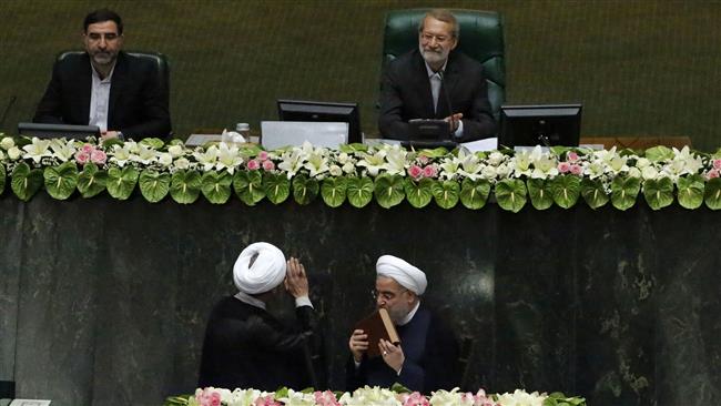 IranIranian Parliament Speaker Ali Larijani (top-R) smiles during the swearing-in ceremony of President Hassan Rouhani (bottom-R) before the parliament in Tehran, Iran, August 5, 2017. (Photo by AFP)
