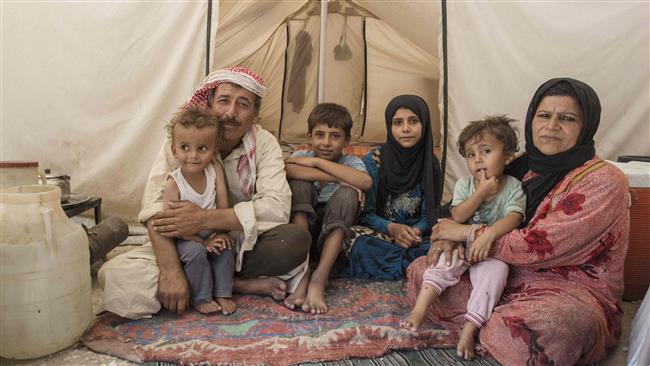 A handout picture released by Save The Children on August 2, 2017 shows Syrian siblings Yacoub (C-L), 12, and Faridah (C-R), 13, from Raqqah, sitting with their parents inside a tent in Ain Issa. (Photo by AFP)
