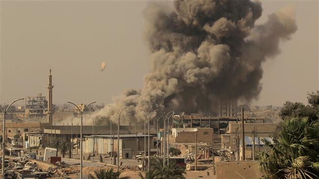 Smoke rises after a US-led airstrike during fighting between members of the so-called Syrian Democratic Forces and the Daesh Takfiri terrorists in Raqqah, Syria, on August 15, 2017. (Photo by Reuters)
