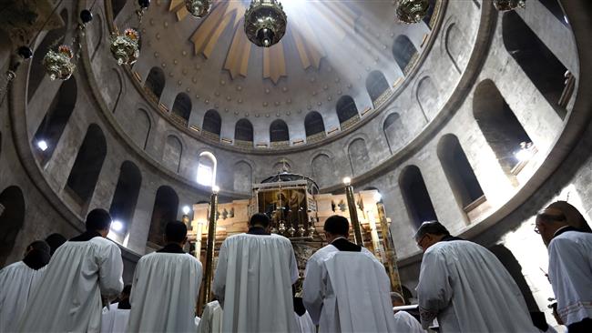 Roman Catholic clergy pray during the Easter Sunday procession at the Church of the Holy Sepulchre in the Old City of Jerusalem al-Quds on April 16, 2017. (Photo by AFP)
