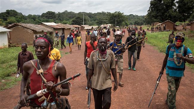 Anti-balaka fighters walk in Gambo, southeast Central African Republic, on August 16, 2017. (Photo by AFP)
