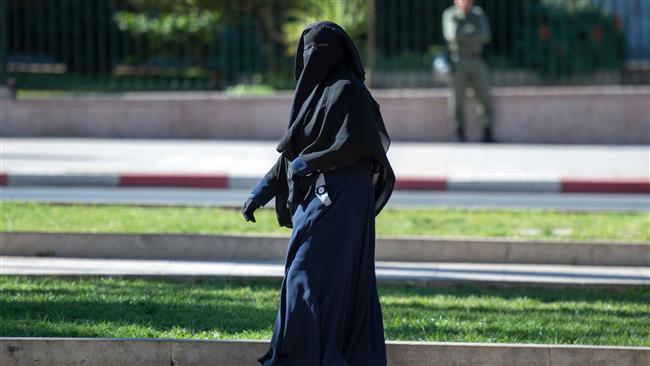 A woman wearing a niqab walks along a street in Rabat, Morocco, on January 15, 2017. (Photo by AFP)
