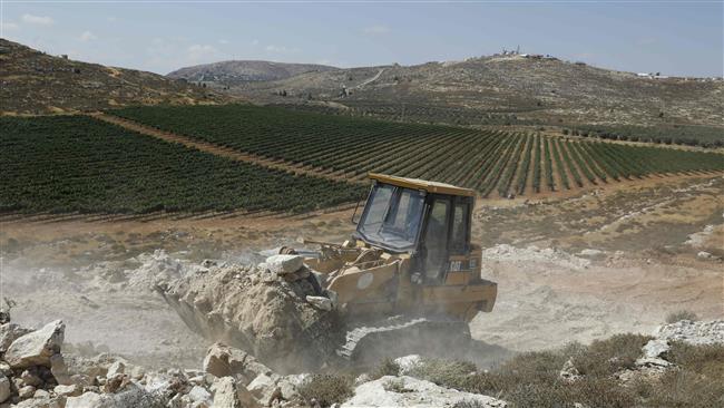 A worker uses a bulldozer to clear the land for the new Amichai settlement, near the Shilo settlement between Ramallah and Nablus in the Israeli-occupied West Bank, June 20, 2017. (Photo by AFP)
