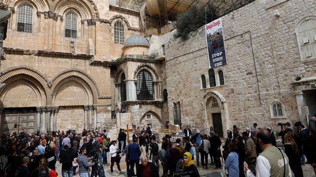 Pilgrims and journalists gather in the yard of the Church of the Holy Sepulchre in Jerusalem al-Quds