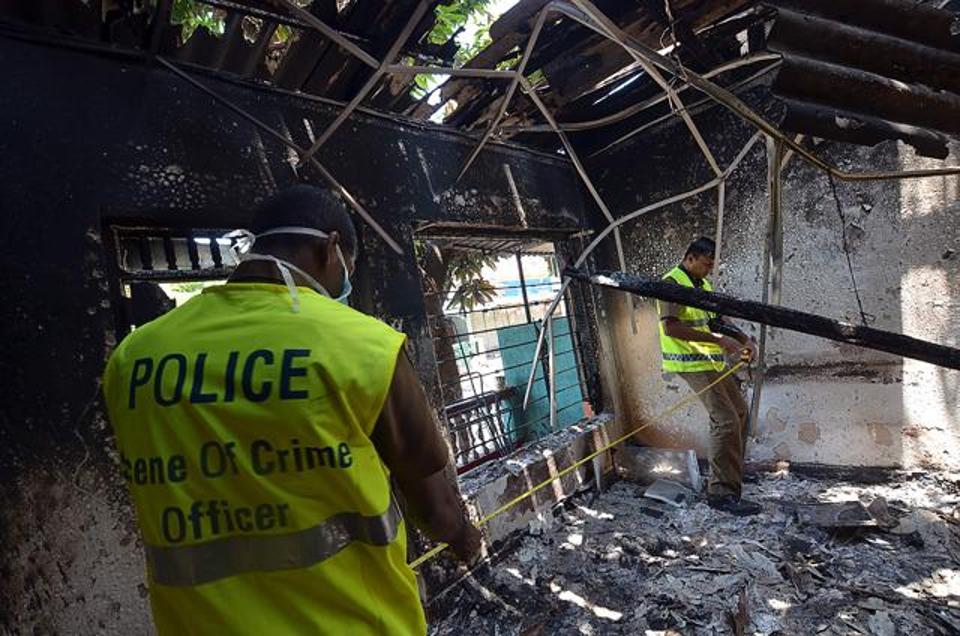 Sri Lankan police look at a burnt home in Digana, a suburb of Kandy, on Thursday. Sri Lankan police said petrol bombs were hurled at a mosque as hundreds of troops patrolled a troubled central district where anti-Muslim violence has left three people dead. (AFP)
