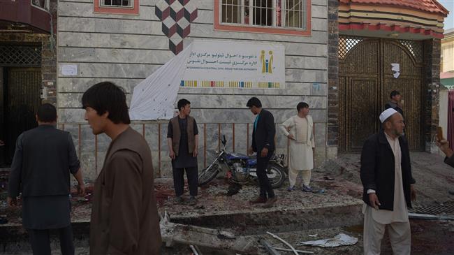 People inspect the site of a bombing outside a voter registration center in Kabul, Afghanistan, April 22, 2018. (Photo by AFP)
