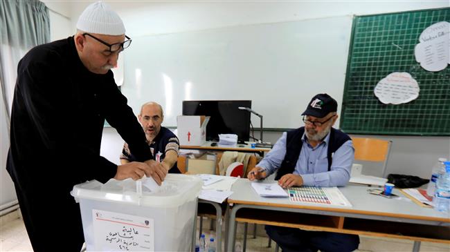 A Lebanese man casts his vote at a polling station during the parliamentary elections in Lebanon on May 6, 2018. (Photo by Reuters)
