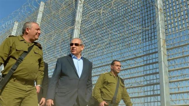 This photo taken from Israeli media shows Prime Minister Benjamin Netanyahu (C) during a tour of military posts in the southern parts of the occupied territories.
