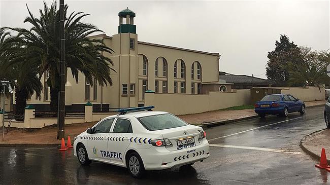 In this picture, taken with a phone, a South African police vehicle is parked outside Malmesbury’s main mosque following a stabbing attack that left two worshippers dead, in Malmesbury, north of Cape Town, on June 14, 2018. (Via AFP)
