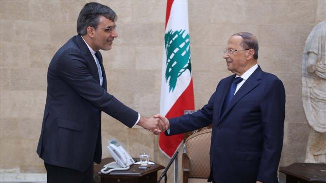 Lebanon’s President Michel Aoun (R) shakes hands with Iranian Foreign Minister