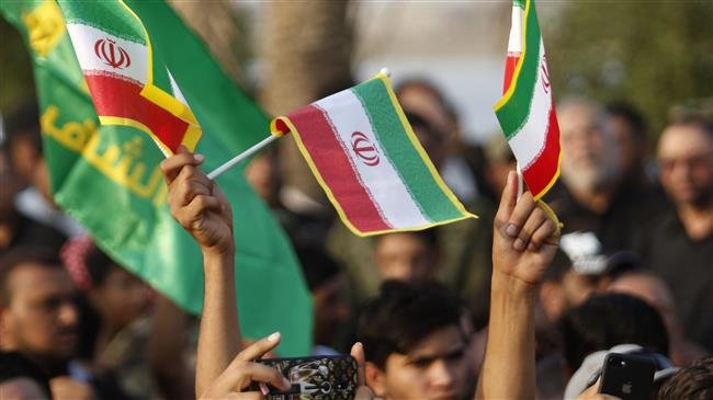 Demonstrators waving Iranian and pro-Iranian party flags during a protest on September 15, 2018, against the torching of the Iranian consulate and the Hashed al-Shaabi party (Popular Mobilization Units) headquarters during recent protests in the southern Iraqi city of Basra. (AFP photo)
