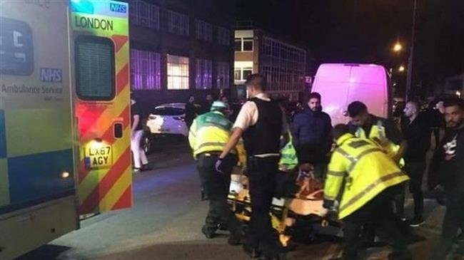 This image released in the British media shows medics attending to people injured in an attack at a mosque in Cricklewood, north of London, on early hours of September 19, 2018.
