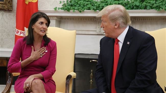 US President Donald Trump (R) announces that he has accepted the resignation of Nikki Haley (L) as the US ambassador to the United Nations, in the Oval Office of the White House on October 9, 2018 in Washington, DC. (Photo by AFP)
