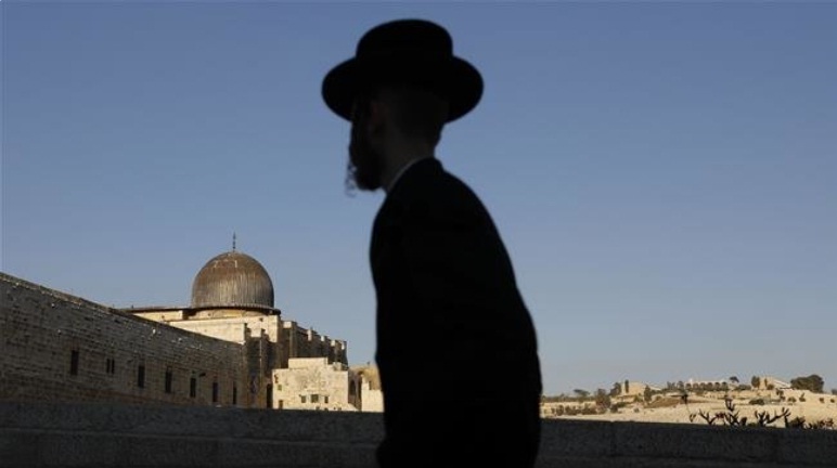 An Ultra-Orthodox Jewish man stands at the Zionist quarter in Jerusalem al-Quds