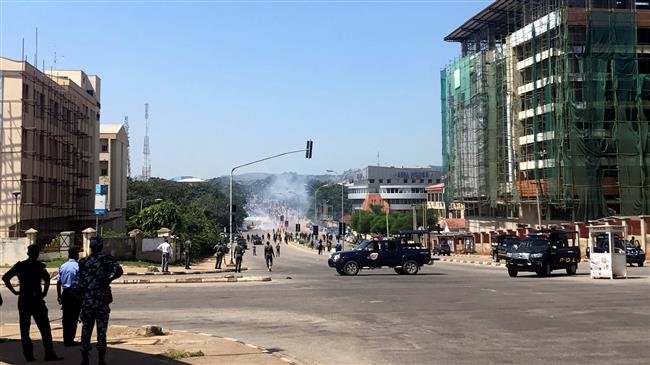 Nigerian security forces are deployed as smoke is seen in the background during a march by the Islamic Movement in Nigeria in Abuja, Nigeria, October 30, 2018. (Photo by AFP)
