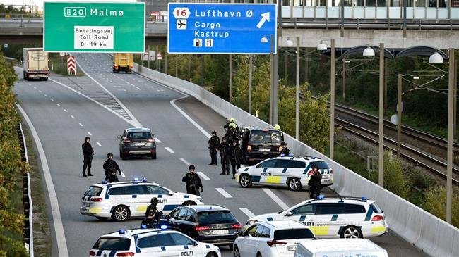 Police vehicles block the street leading to the Oeresund Bridge near Copenhagen on Sept. 28, 2018.
