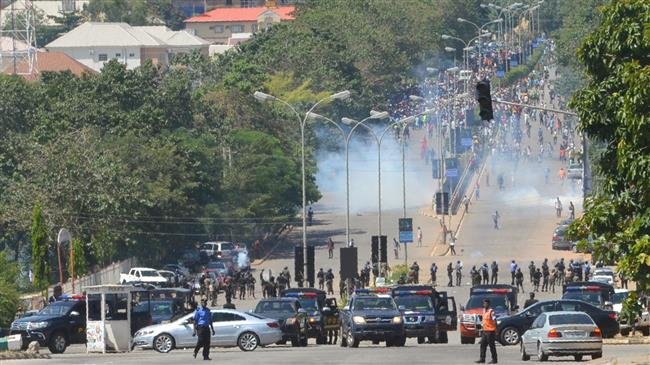 Nigerian police officers fire teargas at supporters of Islamic Movement in Nigeria (IMN) as they protest against the imprisonment of their leader Ibrahim Zakzaky, in Abuja, on October 30, 2018. (Photo by AFP)
