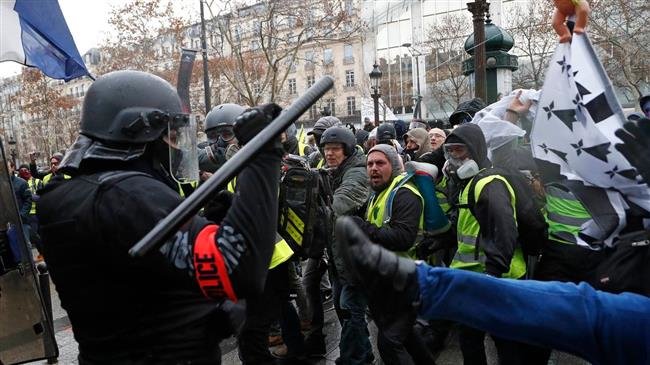 Police officers clash with demonstrators wearing yellow vests in Paris, Saturday, Dec. 8, 2018.
