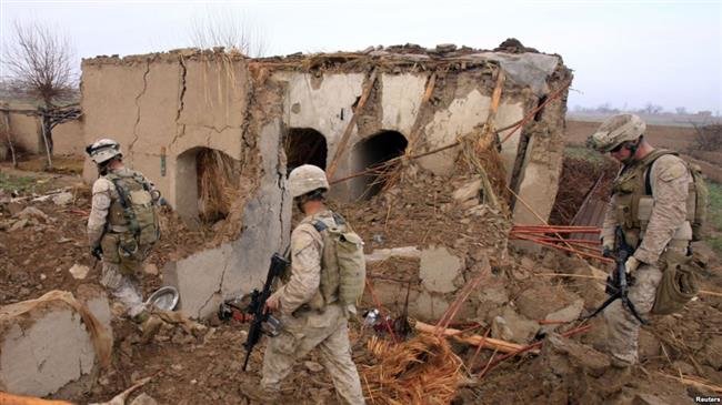 File photo of US troops walking through the rubble of a house in Afghanistan destroyed in a US-led airstrike.

