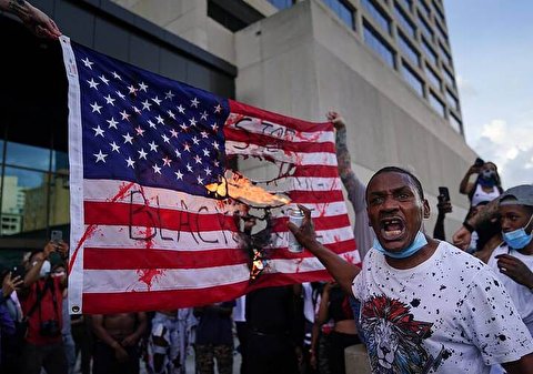 Police deployed in Portland as protesters burn US flag