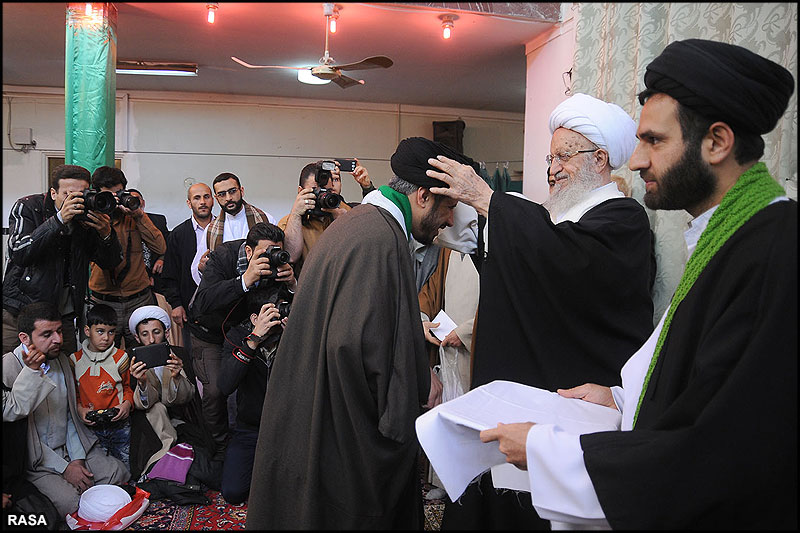 Ayatollah Makarem-Shirazi placing a turban