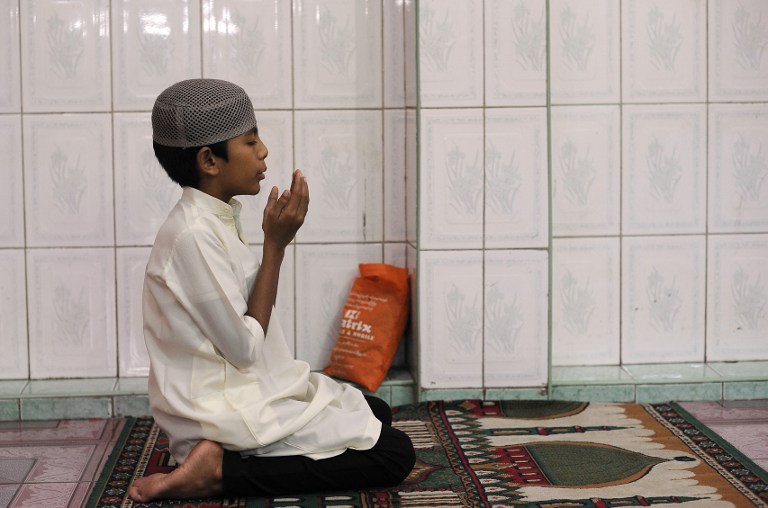  young Myanmar Muslim praying 