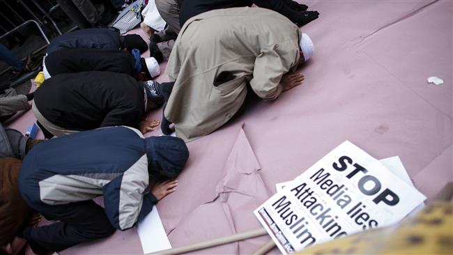 A group of Muslims pray before a rally in front of Trump Tower