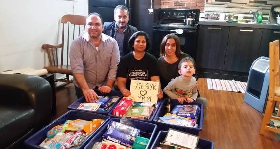 Members of the Syrian Refugee Support Group Calgary fill hampers to send to Fort McMurray evacuees.