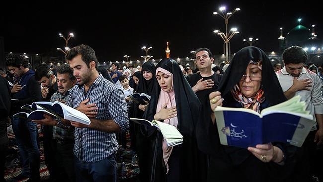 Iranian Muslims ask for divine forgiveness during the Laylat al-Qadr (Night of Destiny) at the courtyard of the holy shrine of the eighth Shia Muslim Imam, Ali ibn Musa al-Reza (PBUH), in the city of Mashhad, northeastern Iran, June ۲۶, ۲۰۱۶.