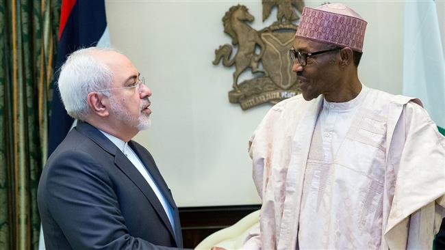 Iran’s Foreign Minister Mohammad Javad Zarif shakes hands with Nigerian President Mohammadu Buhari during a visit to the Nigerian capital, Abuja, July ۲۵, ۲۰۱۶