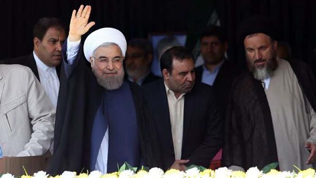 Iranian President Hasan Rouhani waves to people in Yasuj, Iran, August 14, 2016