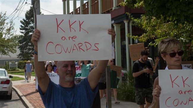 Protesters holding anti-KKK signs