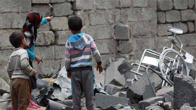 Yemeni children stand amidst the rubble of a house in Yemeni capital, Sana’a, on August 11, 2016, after it was hit by a Saudi airstrike