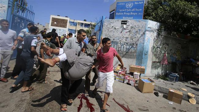 Palestinians carry injured people following an Israeli military strike on a UN school in Rafah, in the southern Gaza Strip