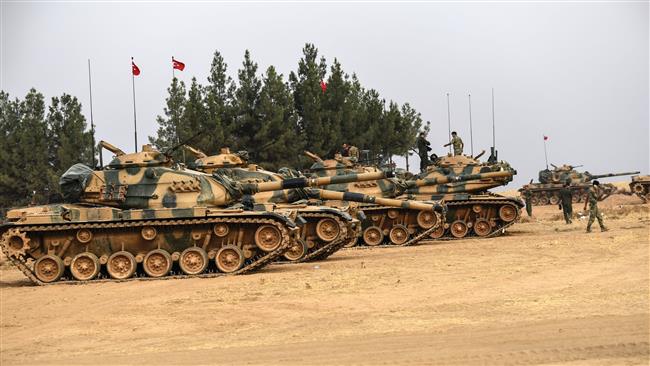 This picture, taken around five kilometers west of the Turkish border city of Karkamis in the southern region of Gaziantep on August 25, 2016, shows Turkish army tanks standing by to roll over into Syria.