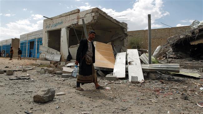 A Yemeni man walks amid the ruins of a building in the capital, Sana’a, on August 29, 2016, after it was hit by a Saudi airstrike