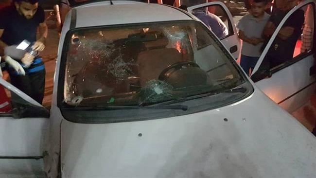 Palestinians inspect a car with bullet marks on its windshield at the Shu’fat refugee camp, north of Jerusalem al-Quds, early on September 5, 2016.
